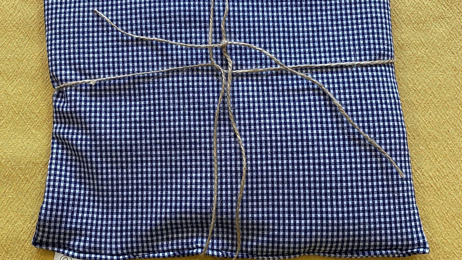 a blue and white checkered fabric with a string tied around it