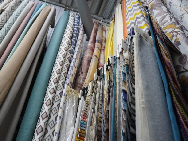 a group of fabric rolls in a store