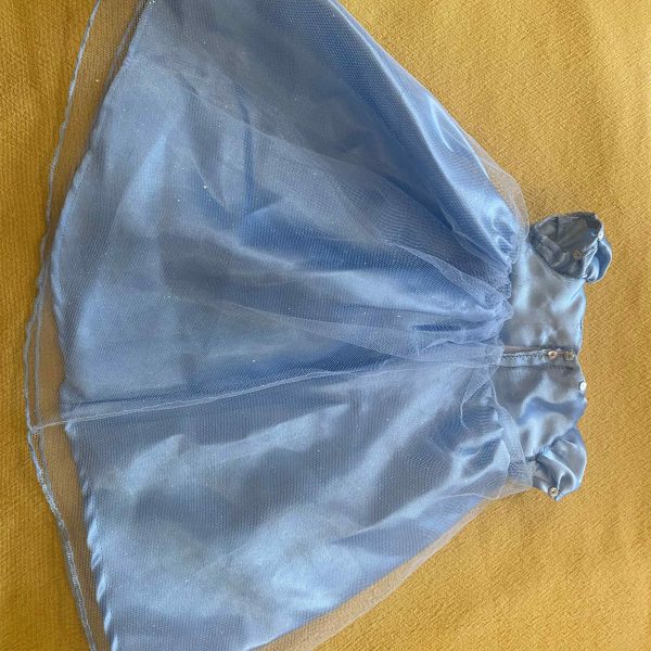 a blue dress on a yellow surface
