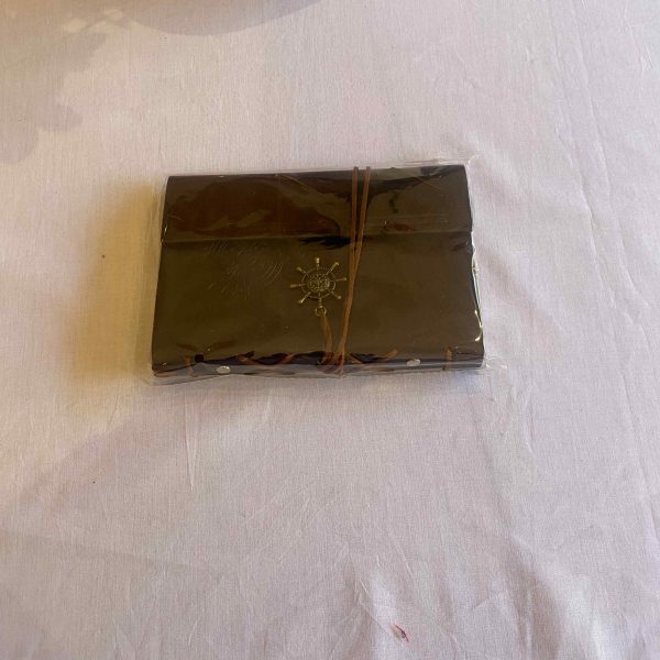 a black rectangular object with a string on a white surface