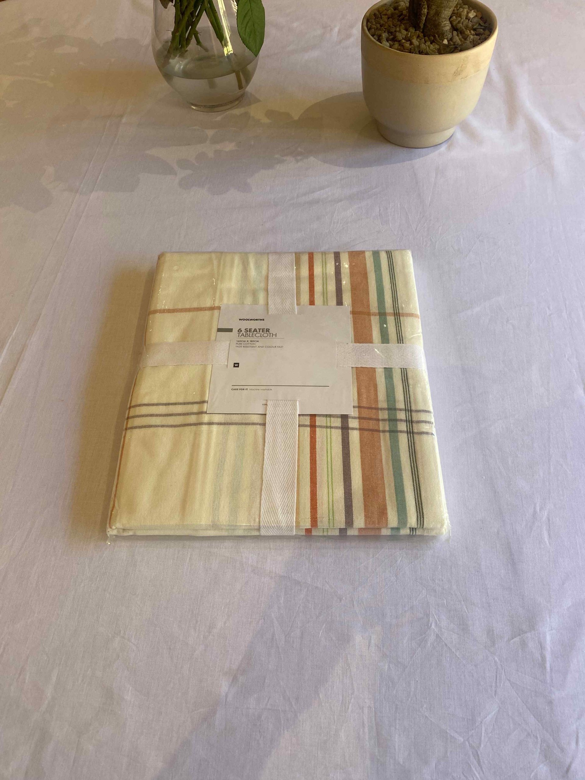 a table with a napkin and a vase