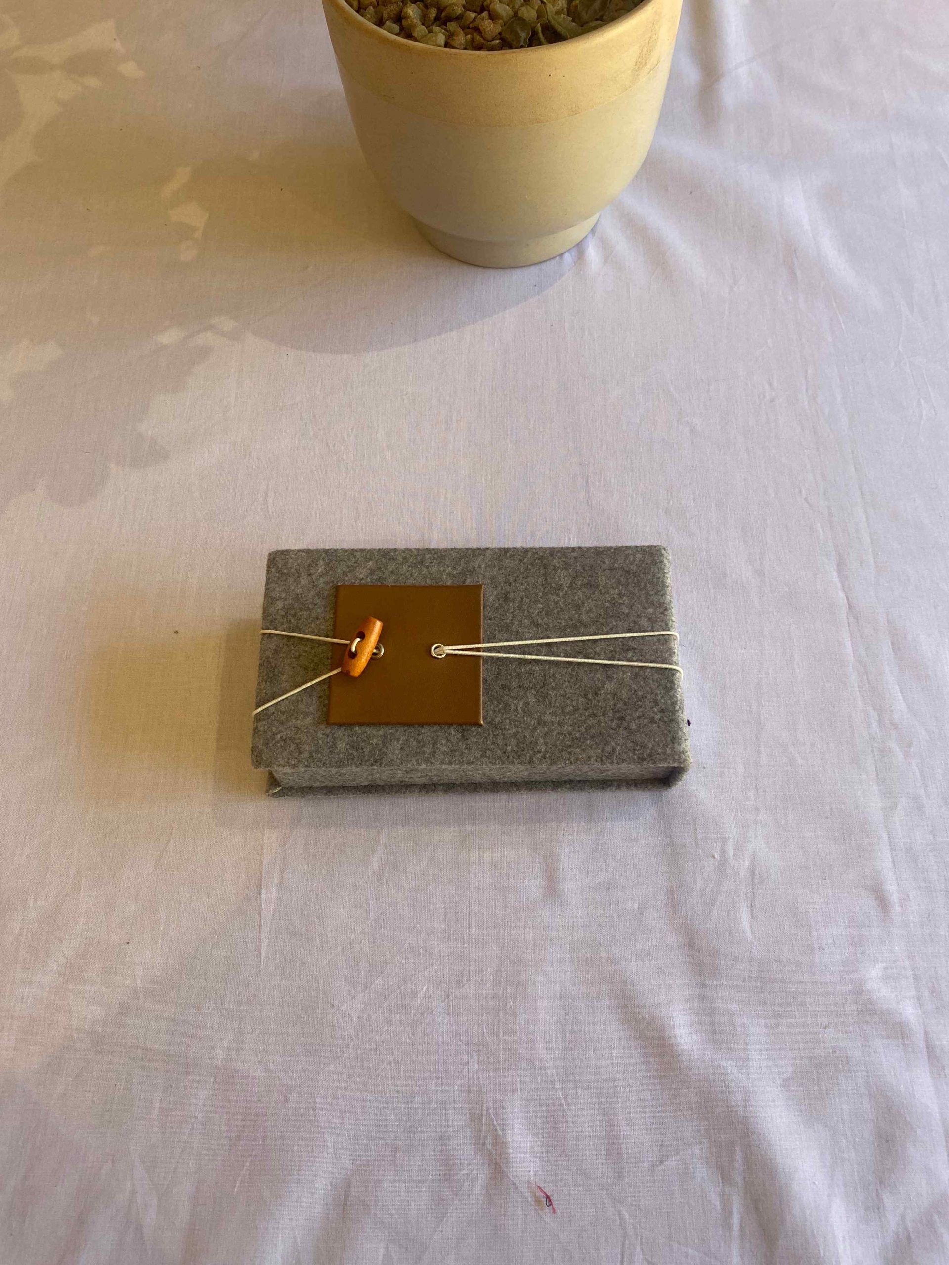a grey rectangular object with a brown square on it