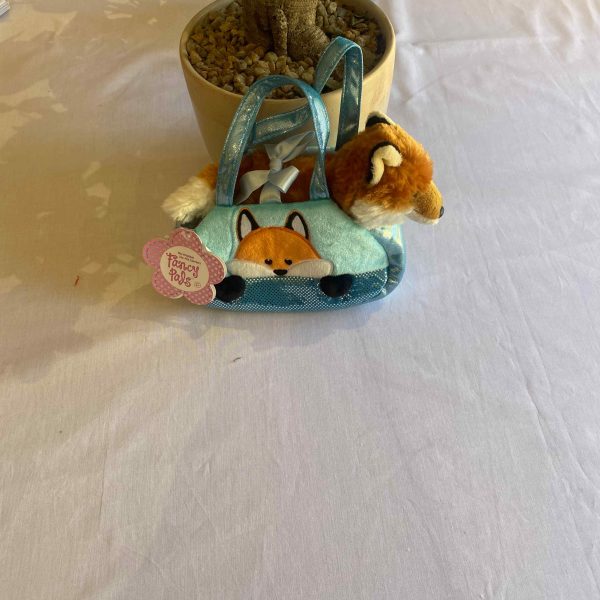 a small stuffed animal in a bag
