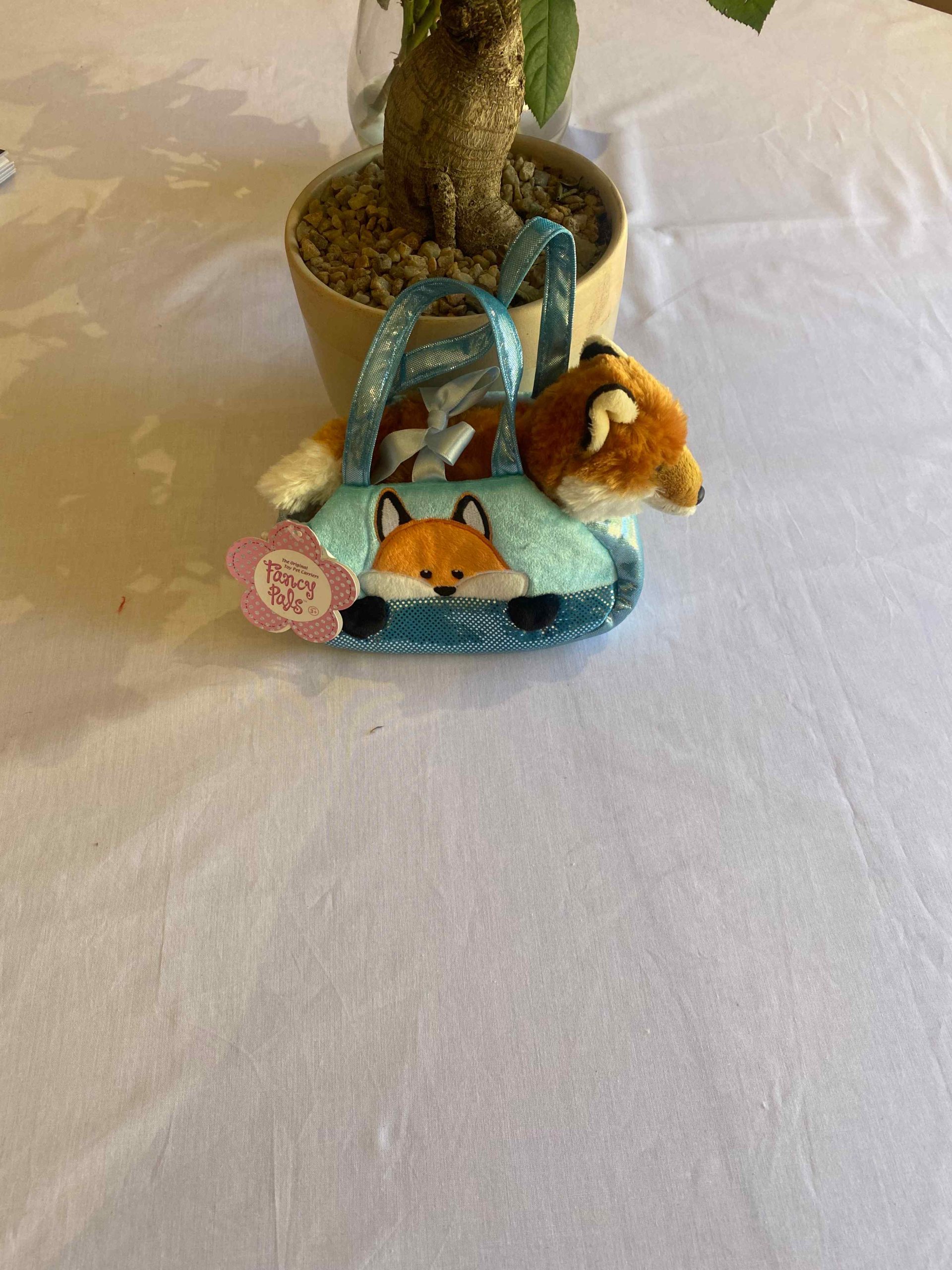 a small stuffed animal in a bag