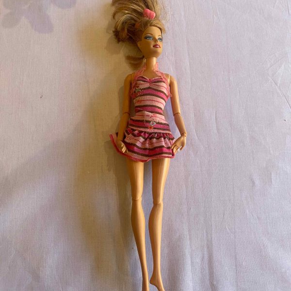 a doll lying on a white surface