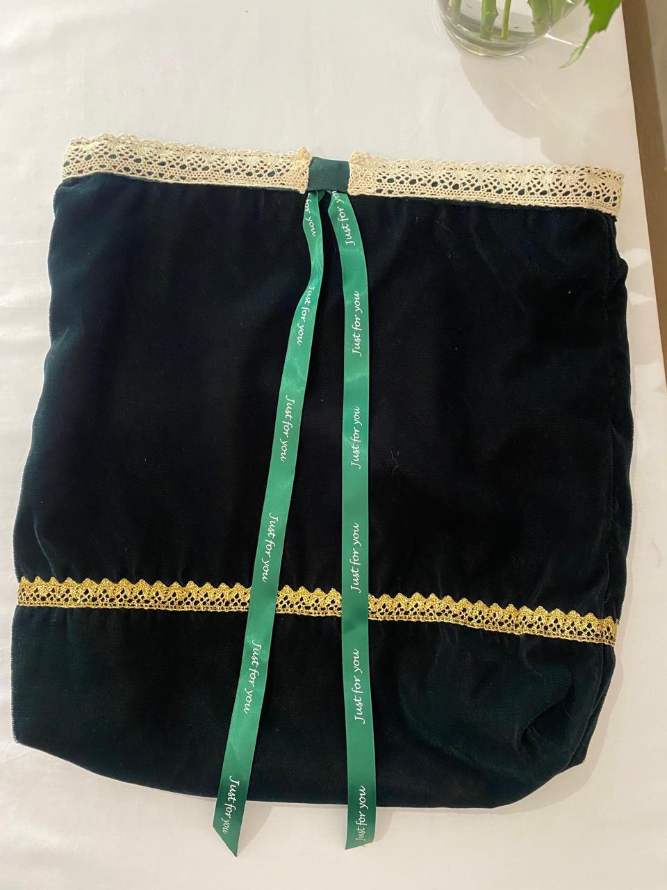 a black fabric with a green ribbon