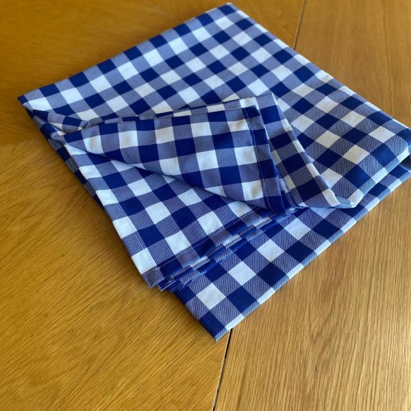a blue and white checkered napkin on a wooden table